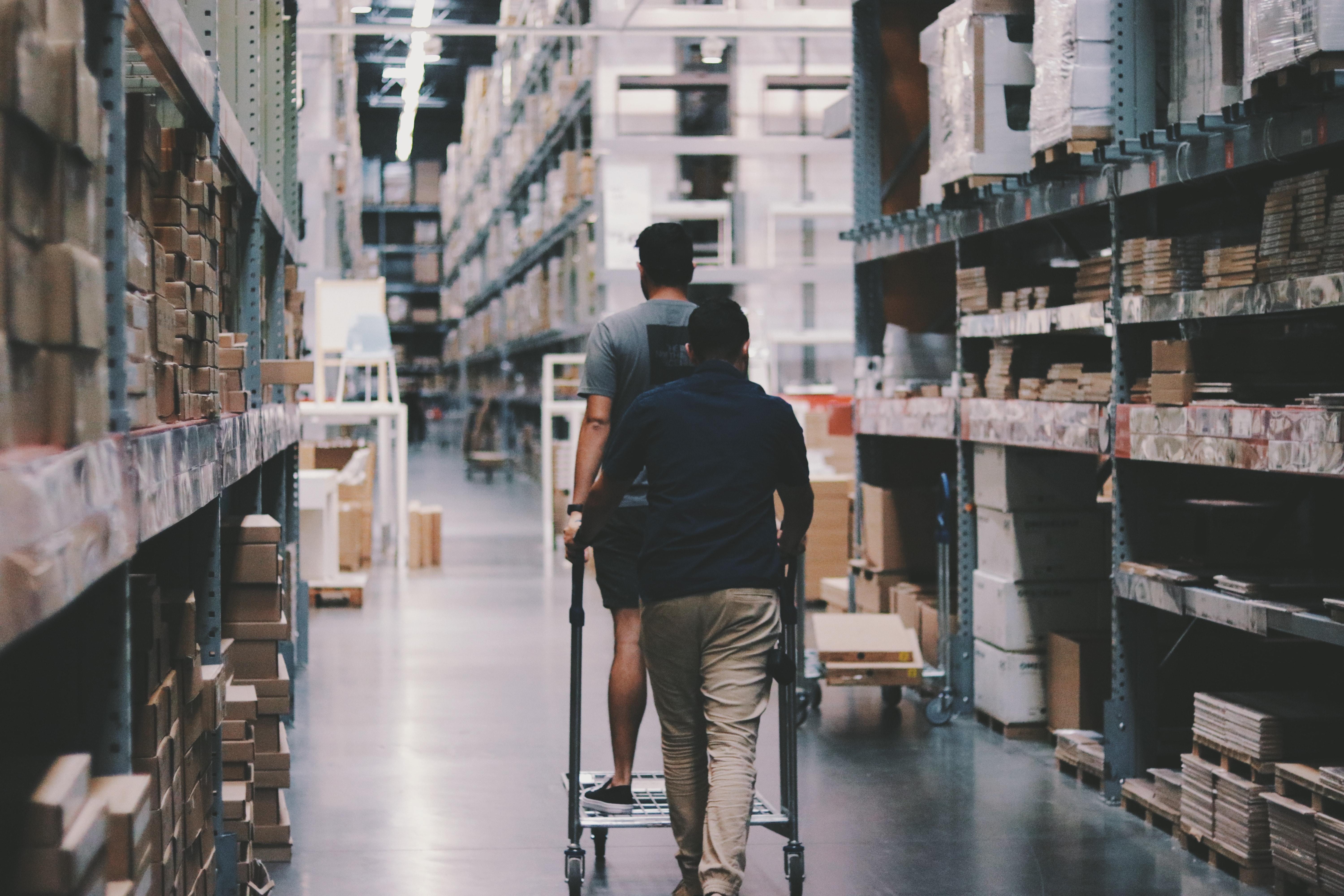 Men walking through inventory in warehouse